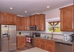 The kitchen features modern stainless-steel appliances